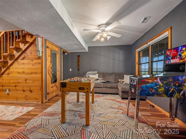 recreation room with ceiling fan and light hardwood / wood-style floors