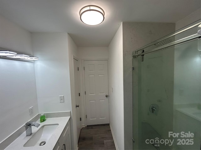 bathroom featuring vanity, wood-type flooring, and walk in shower