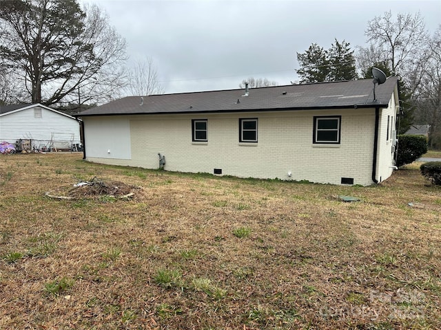 rear view of property with a lawn