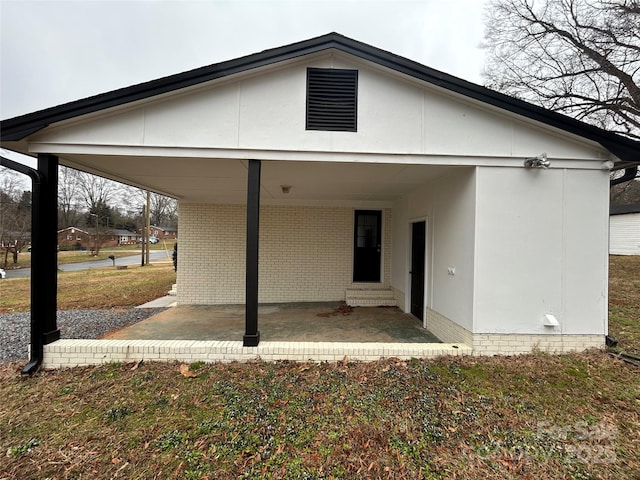 rear view of house featuring a carport