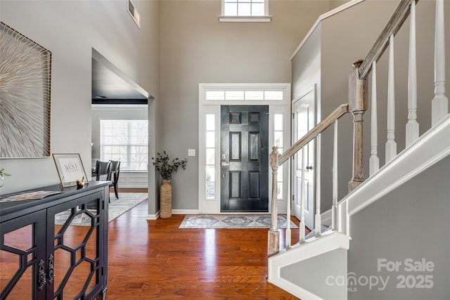 entrance foyer featuring hardwood / wood-style floors and a high ceiling