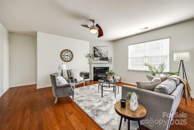 living room with ceiling fan and dark hardwood / wood-style floors