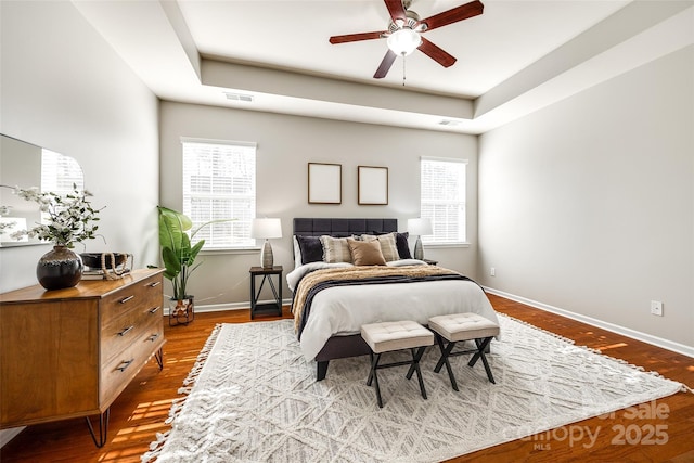 bedroom featuring hardwood / wood-style flooring and multiple windows