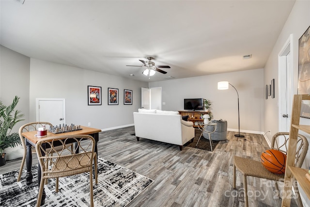 living room featuring hardwood / wood-style floors and ceiling fan