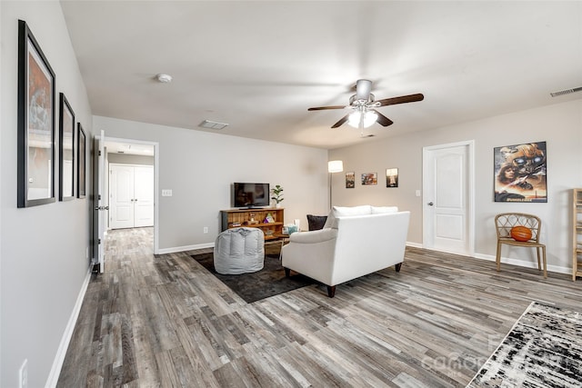 living room featuring ceiling fan and wood-type flooring