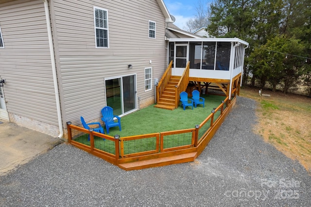 exterior space with a lawn and a sunroom