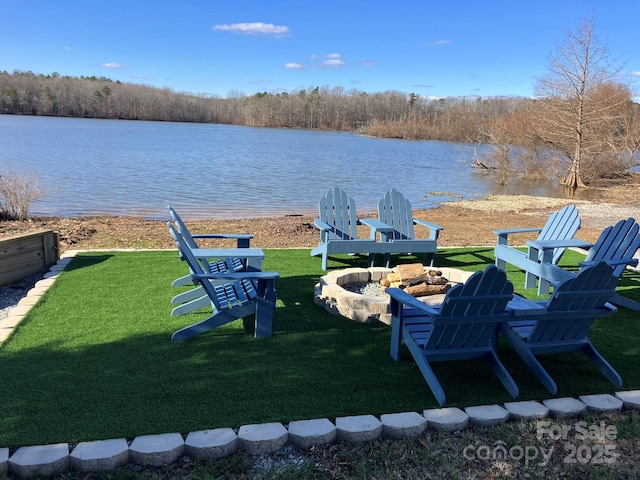 view of yard featuring a water view and an outdoor fire pit