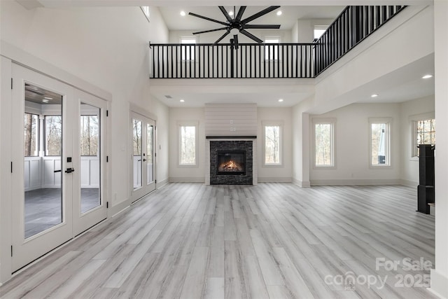 177 Olympia Dr, Mooresville, NC 28117 - unfurnished living room featuring french doors, wood finished floors, and a healthy amount of sunlight