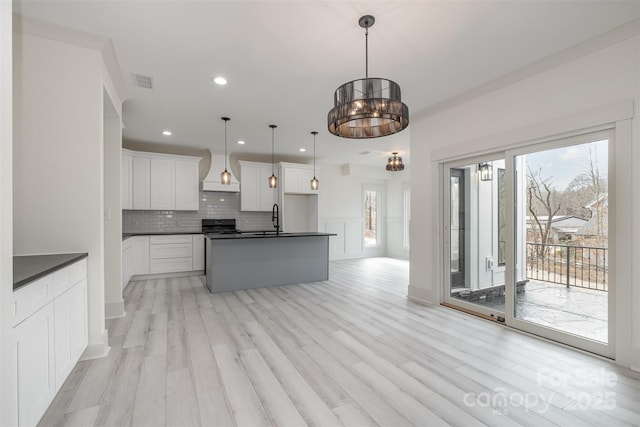 177 Olympia Dr, Mooresville, NC 28117 - kitchen with dark countertops, visible vents, a sink, and backsplash