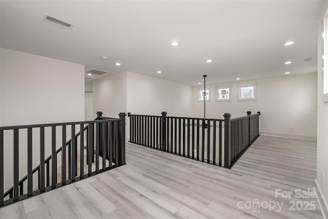 177 Olympia Dr, Mooresville, NC 28117 - hallway featuring visible vents, an upstairs landing, and wood finished floors