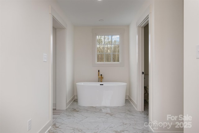 177 Olympia Dr, Mooresville, NC 28117 - full bath with toilet, a soaking tub, baseboards, and marble finish floor