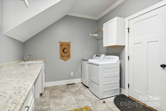 laundry area featuring sink, cabinets, and independent washer and dryer