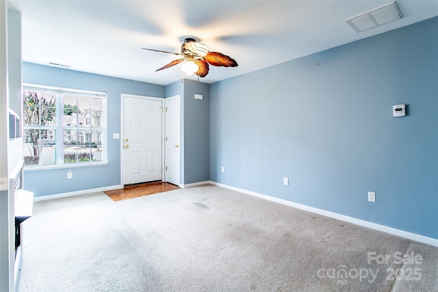 carpeted spare room featuring ceiling fan