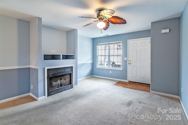 unfurnished living room featuring light colored carpet and ceiling fan