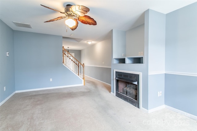 unfurnished living room with ceiling fan and light colored carpet