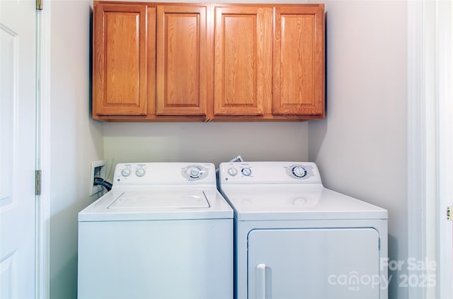 laundry area with cabinets and washing machine and dryer