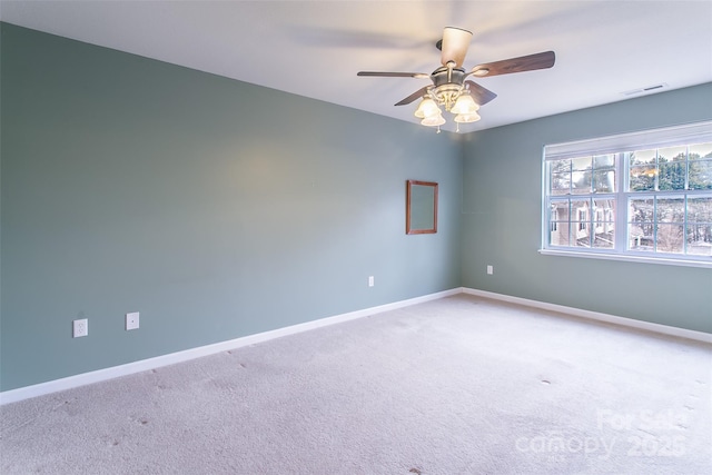 empty room featuring ceiling fan and carpet