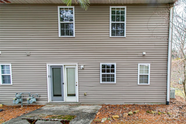 rear view of house with central AC unit