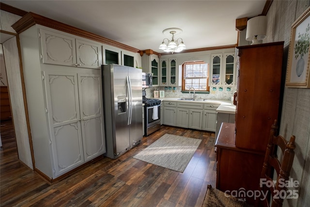 kitchen with pendant lighting, sink, tasteful backsplash, dark hardwood / wood-style floors, and stainless steel appliances