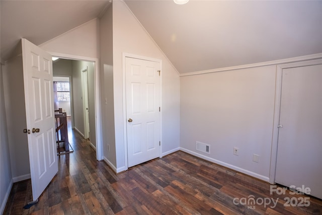 bonus room with dark hardwood / wood-style flooring and lofted ceiling