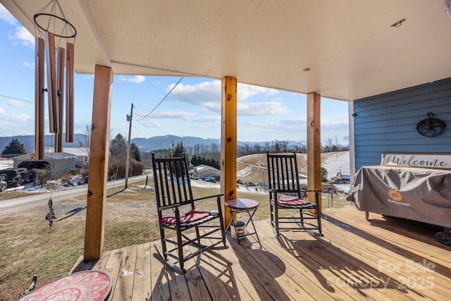 wooden terrace with a mountain view and grilling area