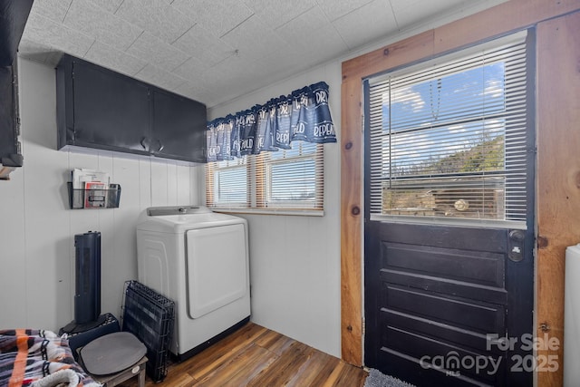 laundry area with cabinets, dark hardwood / wood-style flooring, and washer / dryer