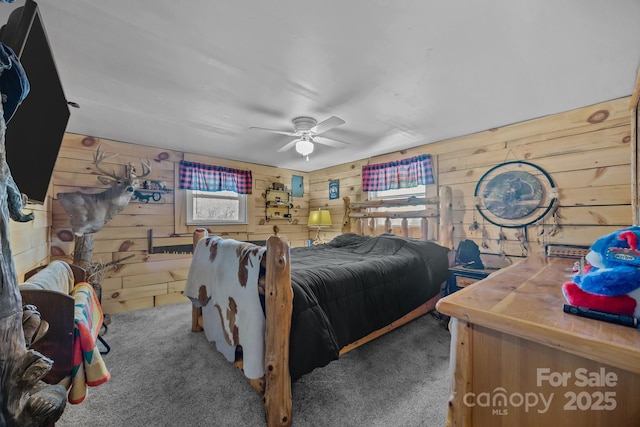 bedroom featuring wood walls, carpet floors, and ceiling fan