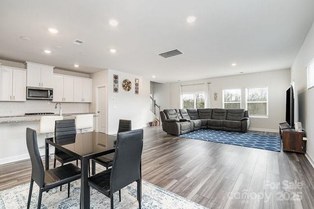 dining space featuring dark hardwood / wood-style flooring and sink