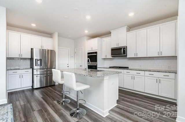 kitchen with white cabinetry and black appliances