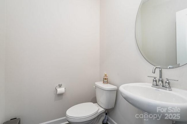 bathroom featuring toilet and sink