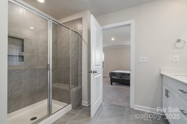 bathroom featuring vanity, a shower with shower door, and tile patterned flooring