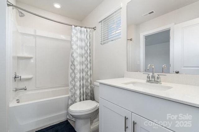 full bathroom with vanity, shower / bath combination with curtain, and toilet