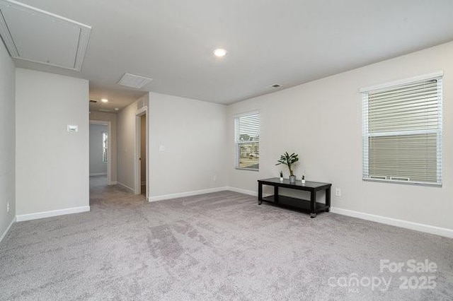 unfurnished room featuring light carpet