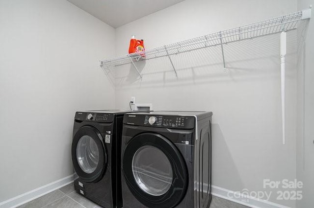 washroom featuring tile patterned flooring and washing machine and dryer