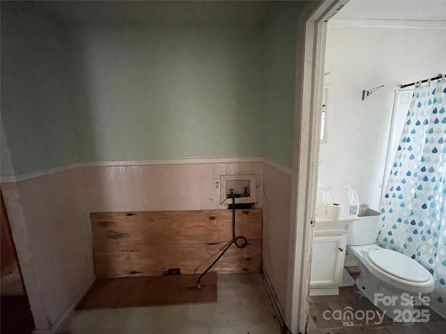 bathroom featuring curtained shower and toilet