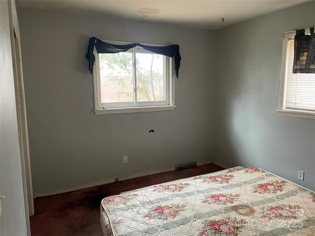 unfurnished bedroom featuring dark colored carpet