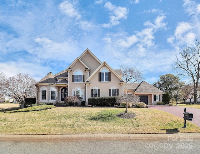 front of property featuring a garage and a front yard