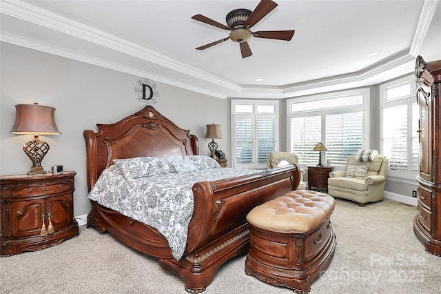 bedroom featuring crown molding, light carpet, and a tray ceiling