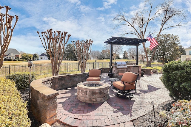 view of patio featuring a fire pit and exterior kitchen