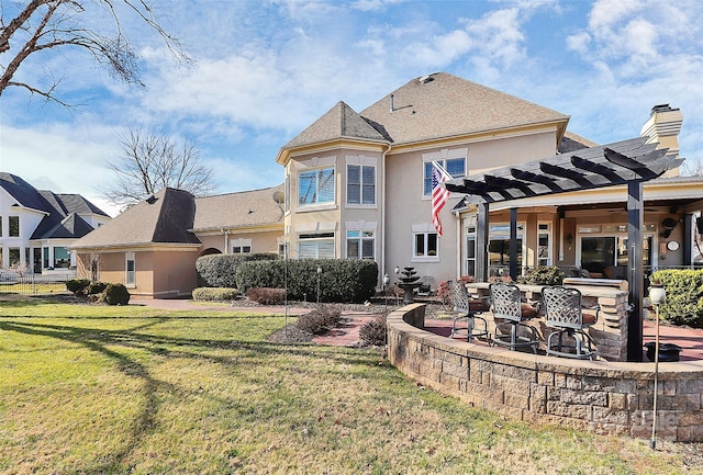 rear view of house with a pergola, a yard, a patio area, and exterior bar