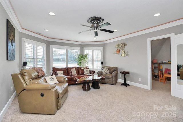 carpeted living room featuring ornamental molding and ceiling fan