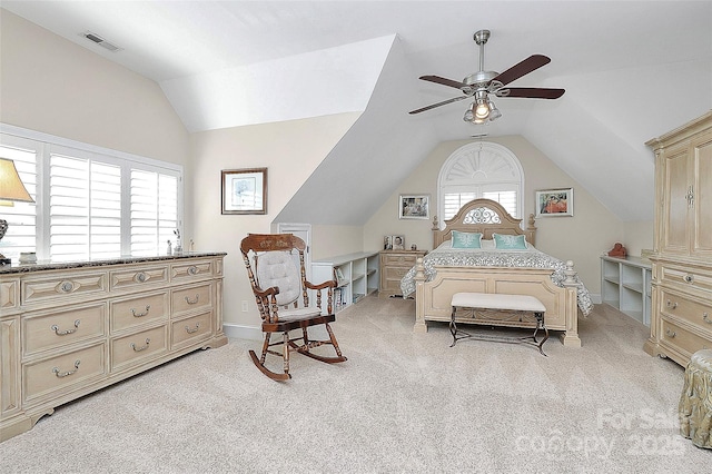 bedroom with ceiling fan, light colored carpet, and vaulted ceiling