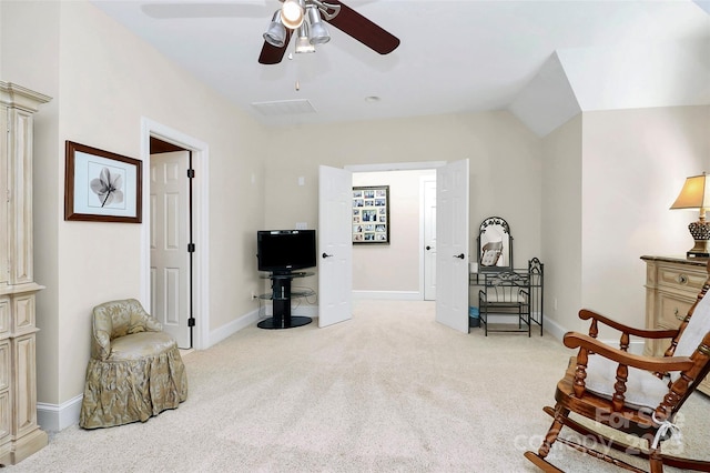 living area with ceiling fan, light colored carpet, and lofted ceiling