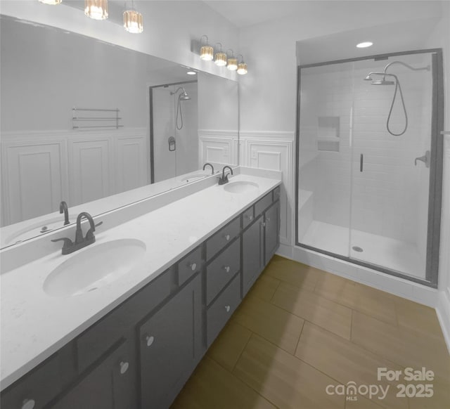 bathroom featuring tile patterned flooring, walk in shower, and vanity