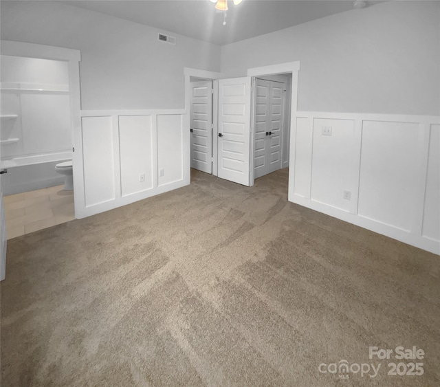 unfurnished bedroom with carpet floors and ensuite bathroom