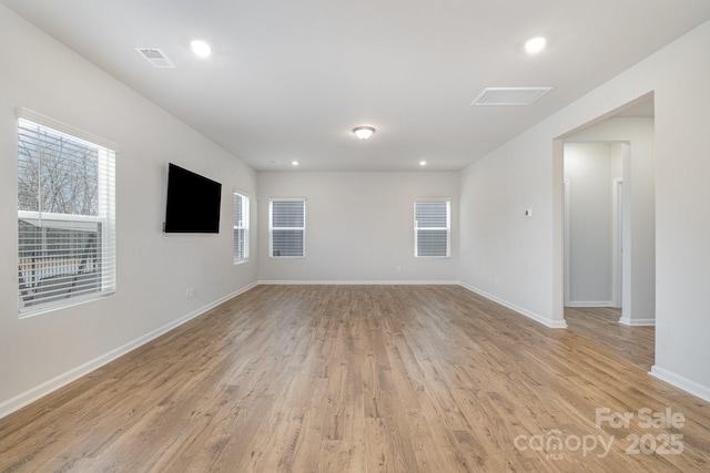 unfurnished room with light wood-type flooring