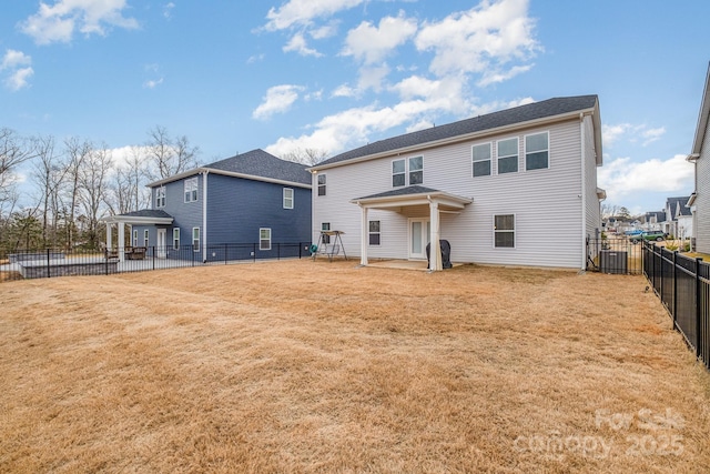 rear view of house with a yard and central AC unit