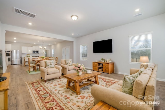 living room with a healthy amount of sunlight and light wood-type flooring