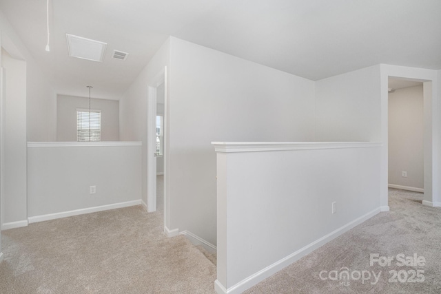 hall featuring light colored carpet