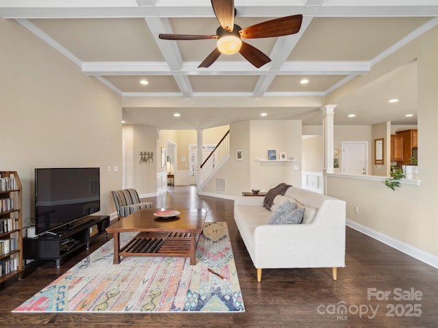 living area featuring ornate columns, baseboards, coffered ceiling, and dark wood-type flooring